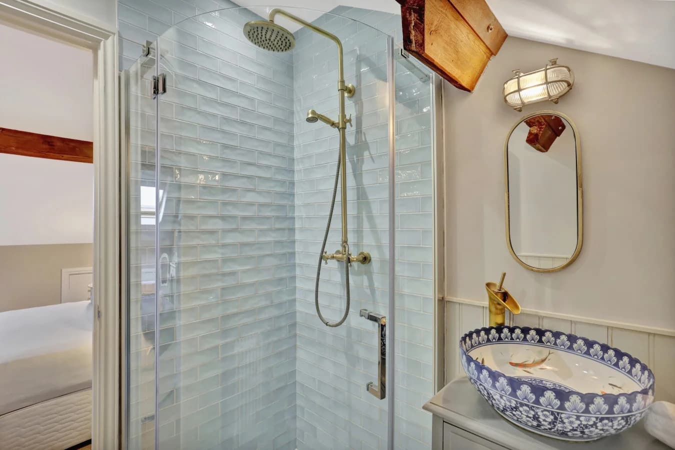 En-suite shower room with patterned basin and brass fittings