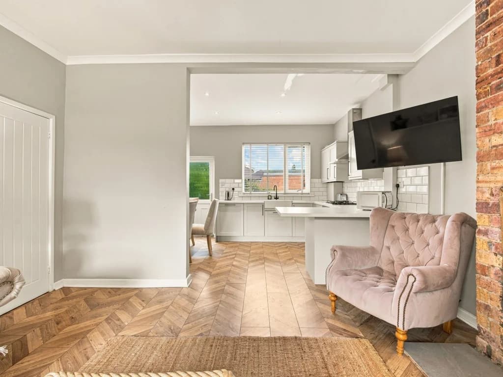 Open-plan living area leading through to the fitted kitchen.