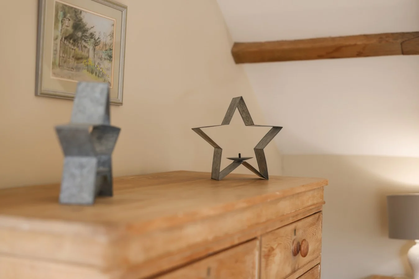 Decorative star ornaments displayed on a wooden chest of drawers