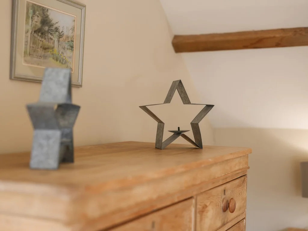 Decorative star ornaments displayed on a wooden chest of drawers