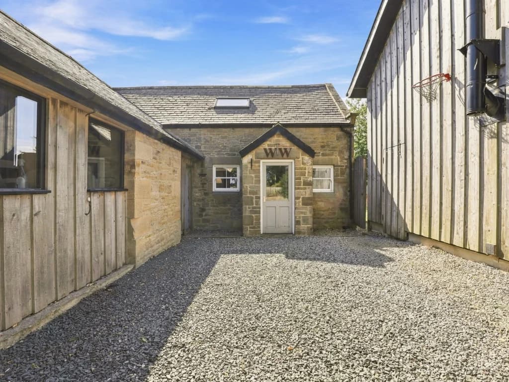 Woodworkers Cottage entrance set within the Rose’s Bower grounds