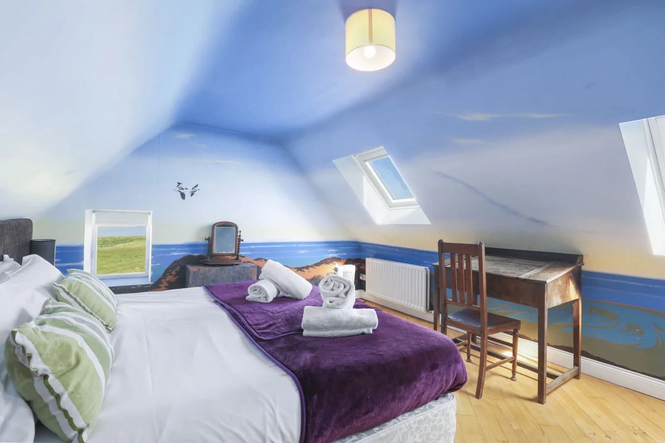 Bedroom with sea views, desk and sloped ceiling