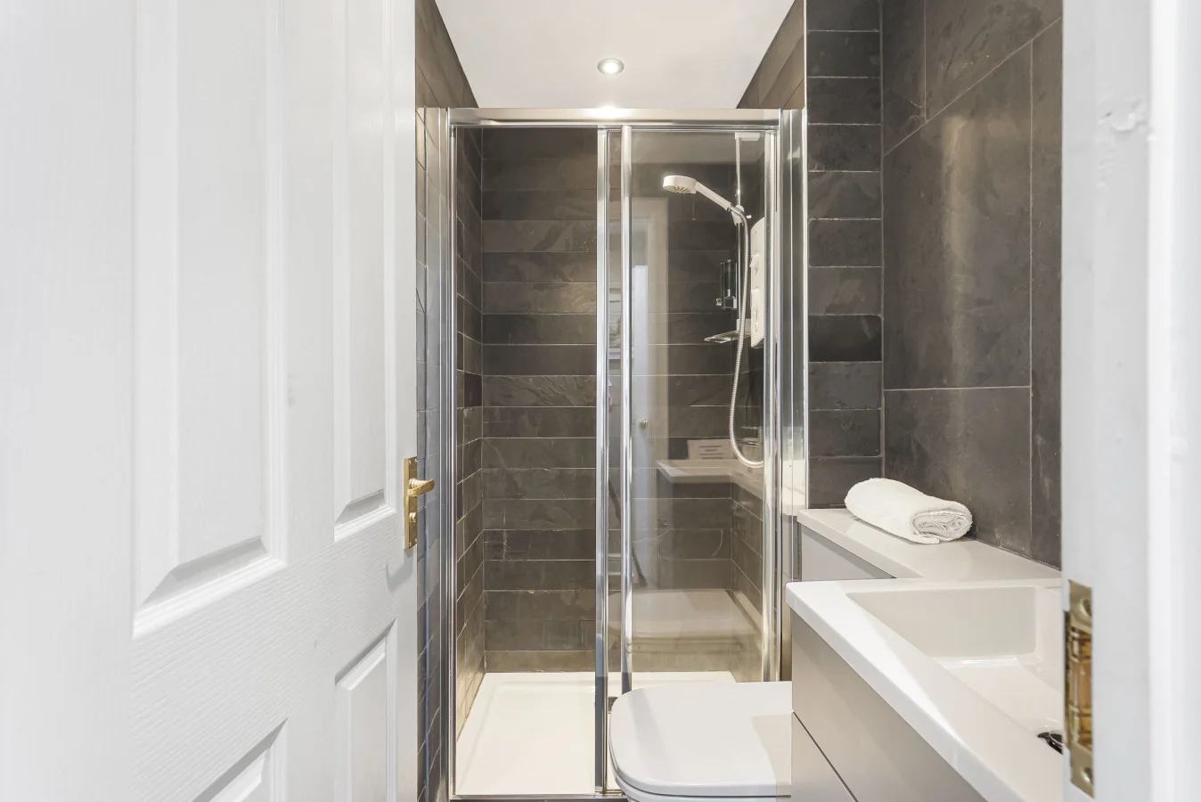 Shower room with walk-in shower and dark wall tiles