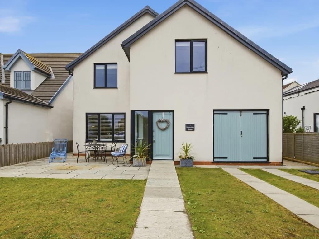 Front lawn, paved seating area and private driveway parking