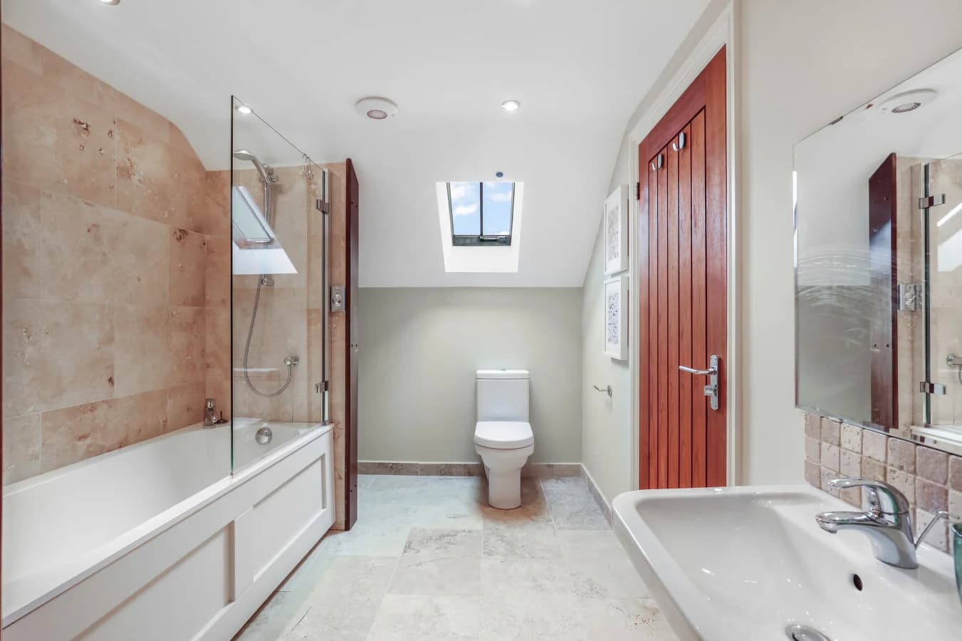 Contemporary en-suite with bath, shower screen and skylight