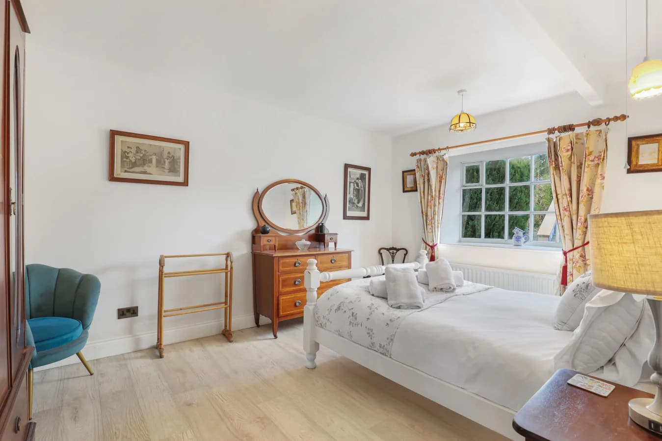 Double bedroom with brass bedframe and dressing table