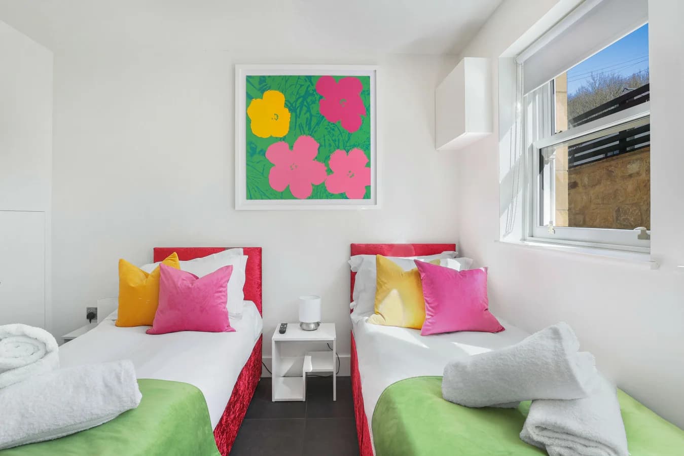 Twin bedroom with twin beds and window seating area