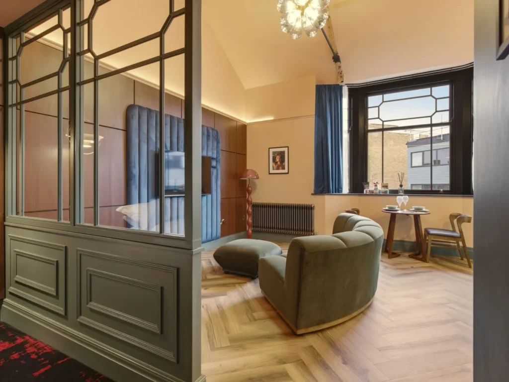 Decorative screen separating the bedroom from the open-plan living area.