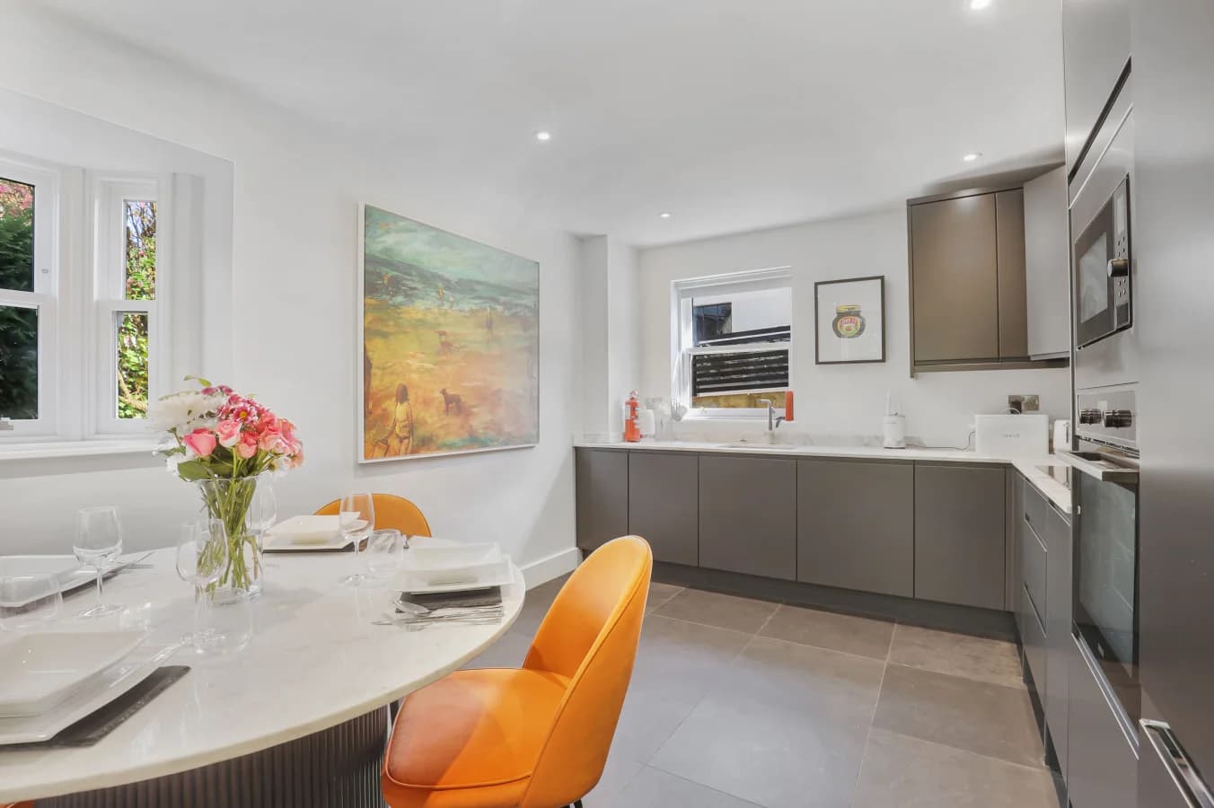 Open-plan kitchen and dining area with quartz table