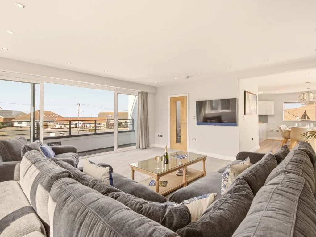 Bright open-plan living area with lounge, dining space and modern kitchen