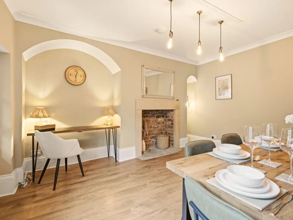Dining area with feature fireplace and seating for family meals.