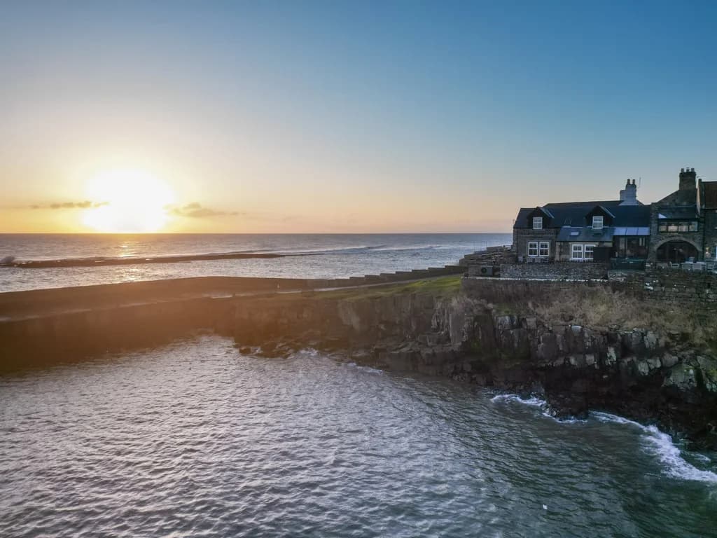 Beautiful golden-hour coastal views across Craster Harbour.