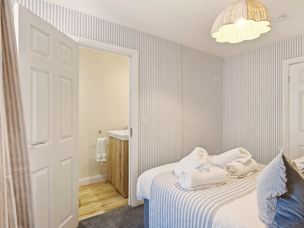 Double bedroom with adjoining WC and wash basin.
