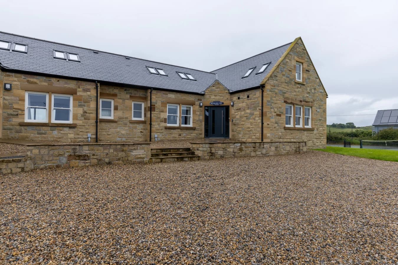 Front elevation of The Duchess with gravel parking area