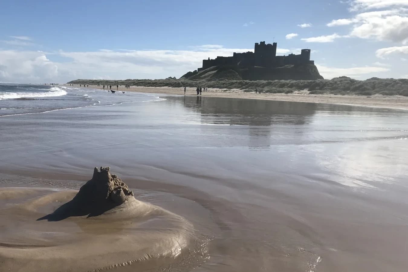Iconic Bamburgh Castle overlooks miles of golden beach and stunning coastal scenery
