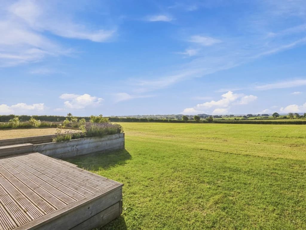 Open lawn and rolling countryside surrounding The Big Barn