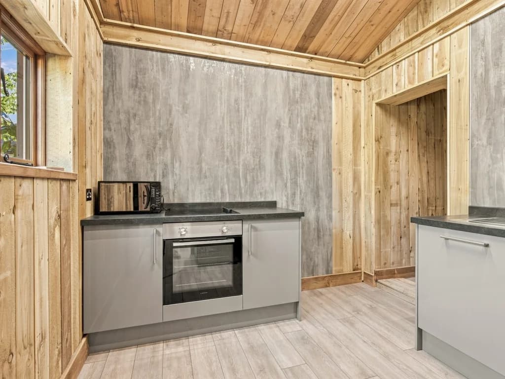 Compact kitchen area with oven, sink and generous worktop space