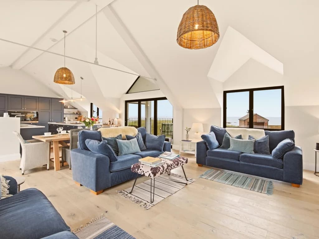 Spacious open-plan lounge with vaulted ceilings and contemporary kitchen