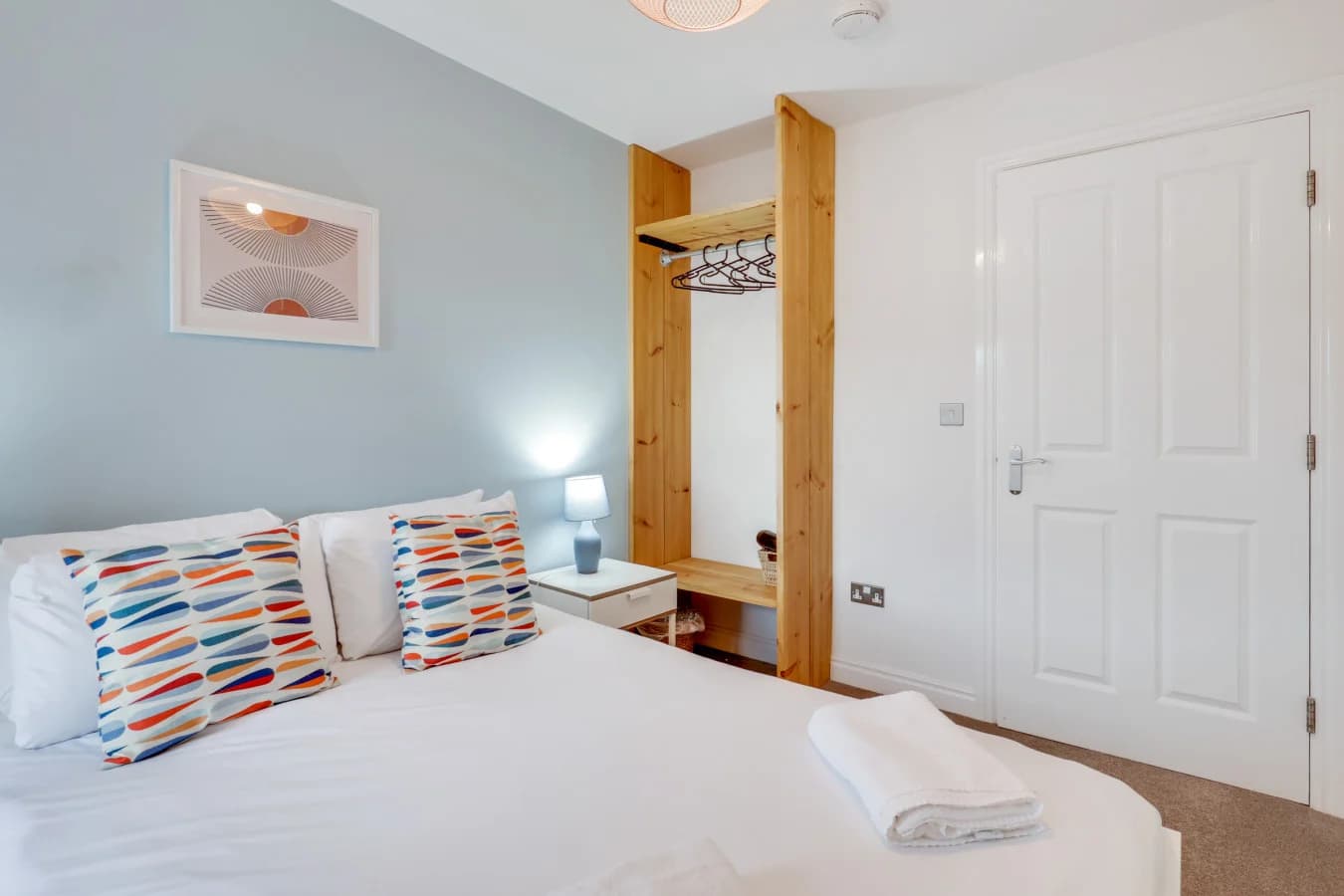 Bright double bedroom with built-in storage and views across Alnwick town centre
