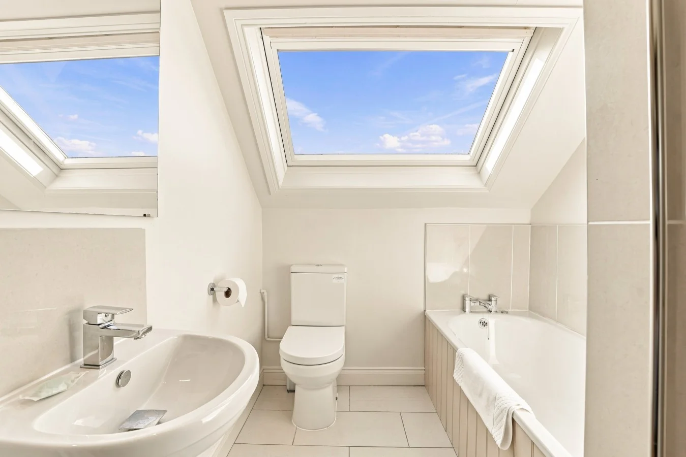 En-suite bathroom with bath, WC, wash basin and skylights
