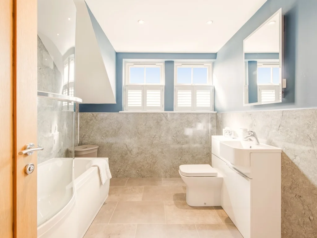 Family bathroom with bath, shower over, WC and modern vanity unit