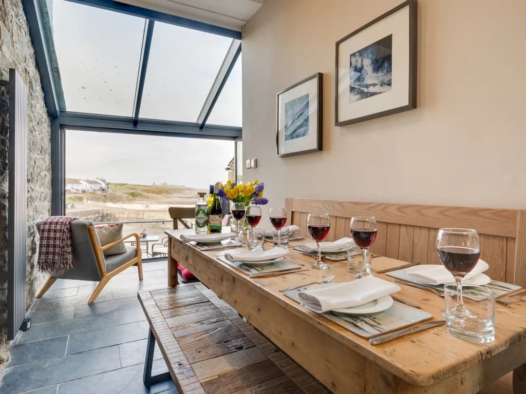 Characterful dining area with coastal views and direct access to the balcony.