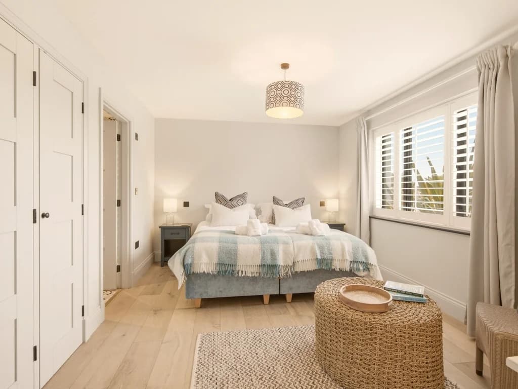 Bright super king bedroom with fitted wardrobes and plantation shutters