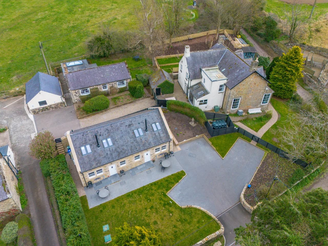 Aerial view of Birdsong Cottage, shared lawn and patio