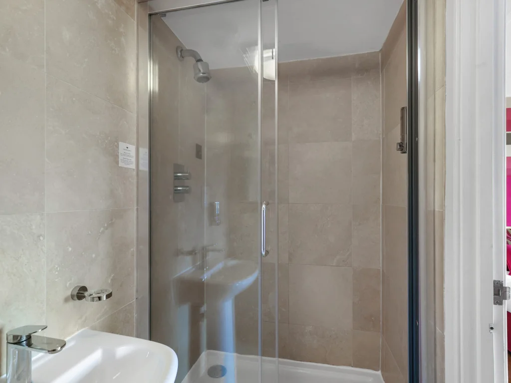 Glass walk-in shower within the ensuite bathroom