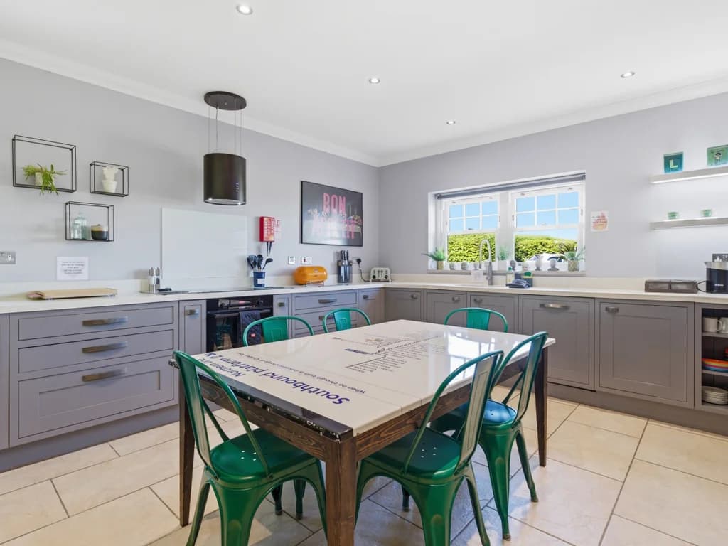 Grey shaker kitchen with Southbound-platform feature table seating six.