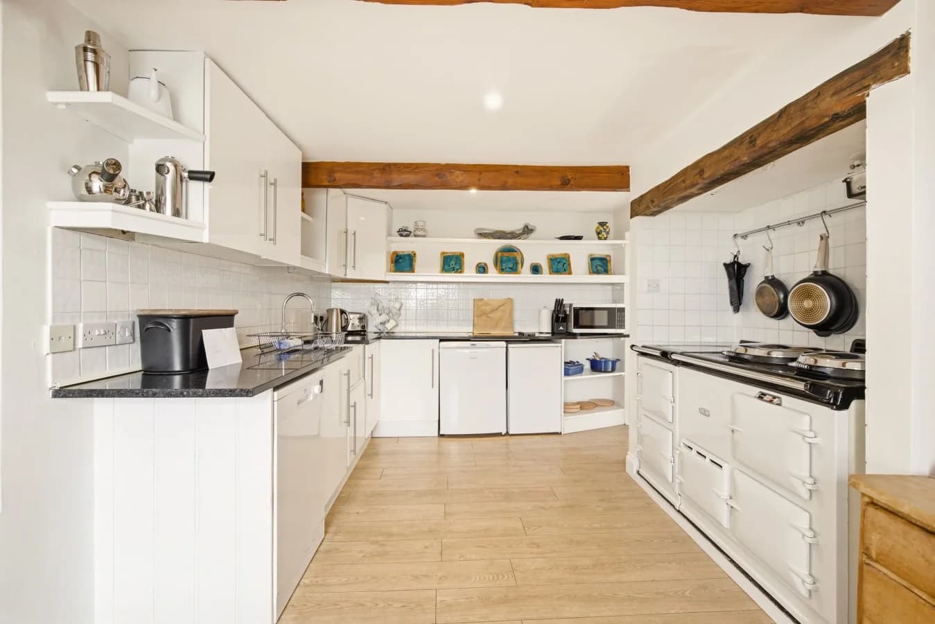 Kitchen with AGA, exposed beams and oak flooring