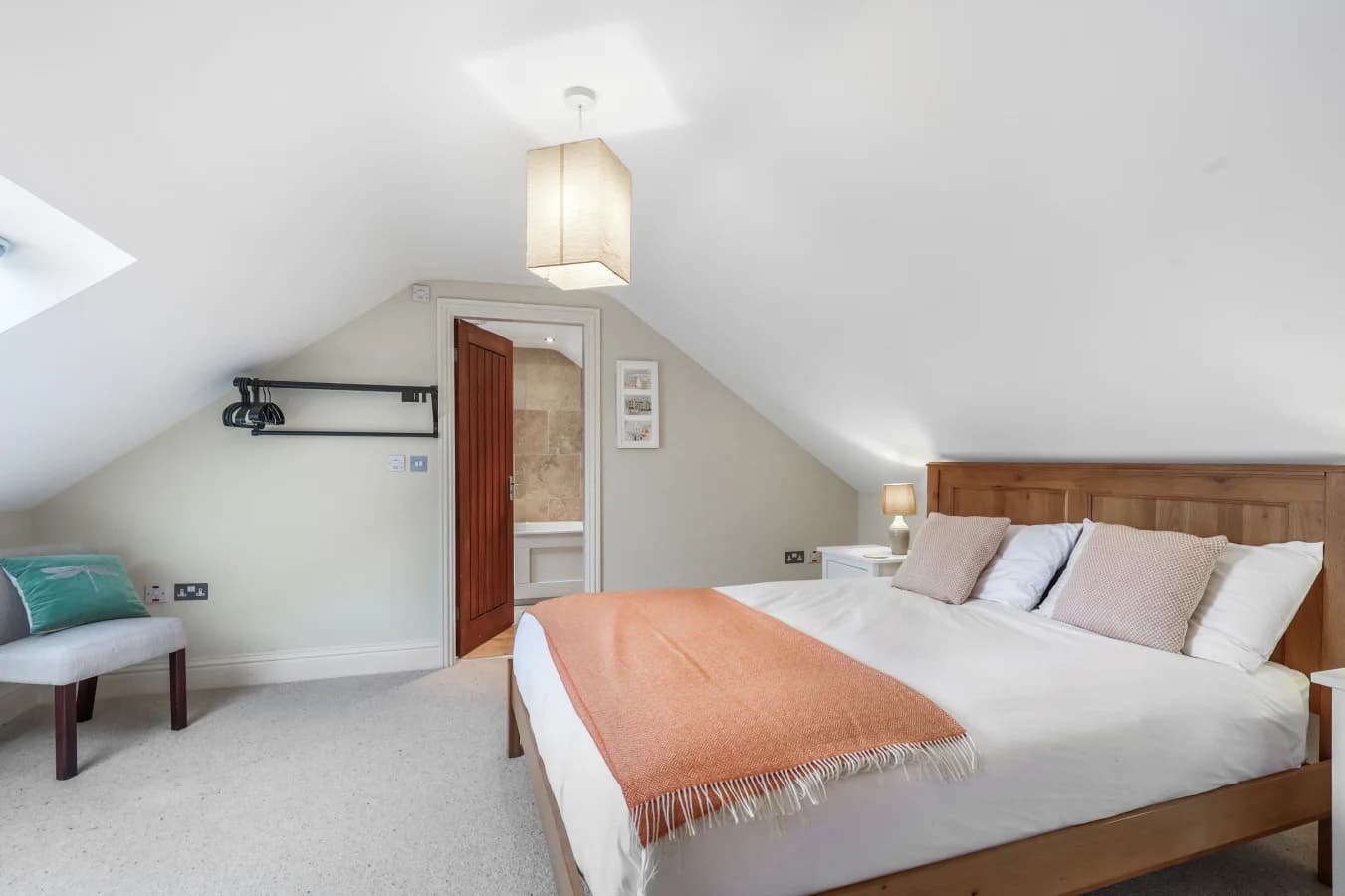 Spacious king bedroom with soft neutral tones and en-suite