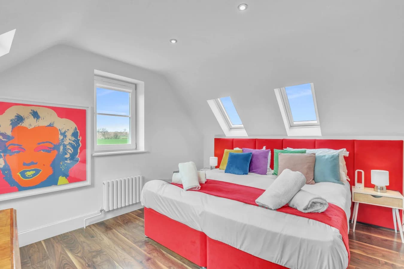 Bright king bedroom with skylights and vibrant décor