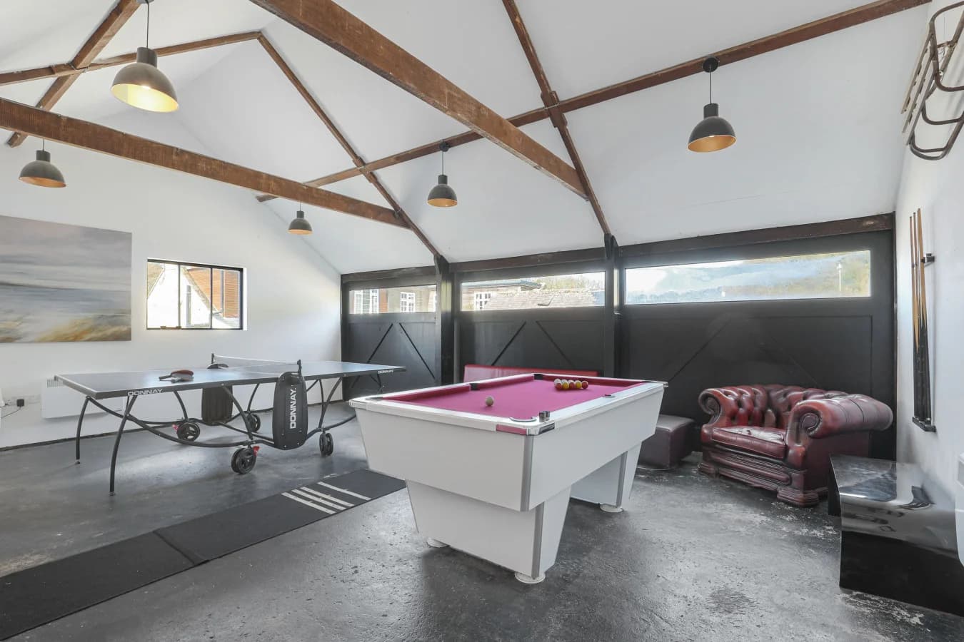 Shared games room with pool table, table tennis and sofas
