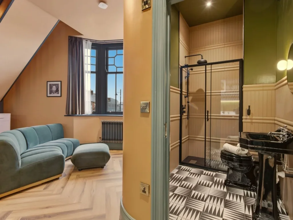 Living area beside the modern shower room with bold patterned flooring