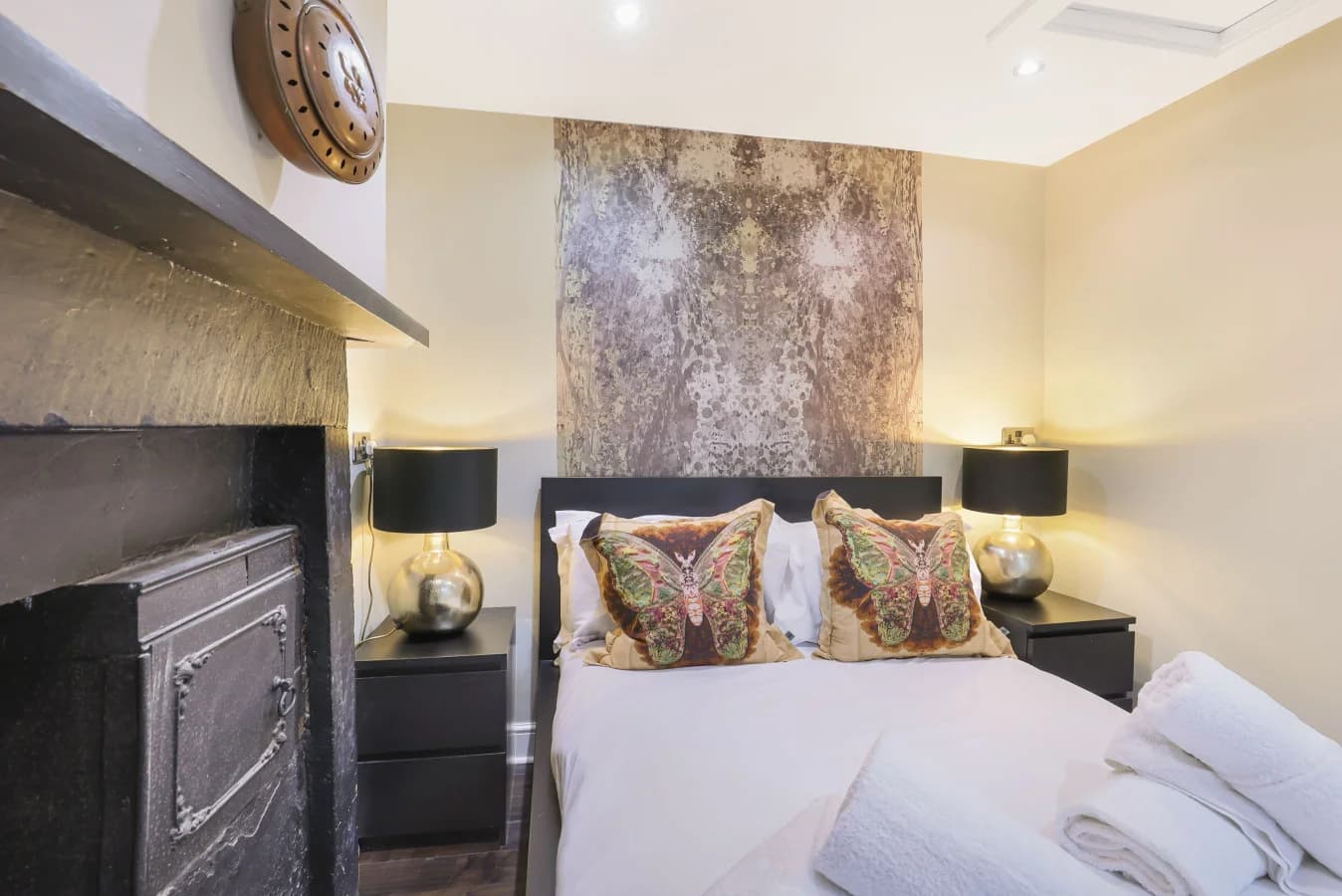 Front-facing angle of the double bedroom with a feature fireplace