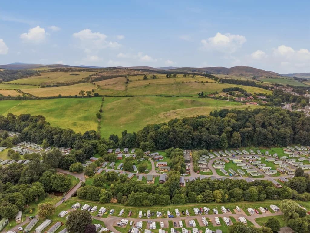 Riverside Holiday Park beneath the rolling landscape of the Cheviot Hills