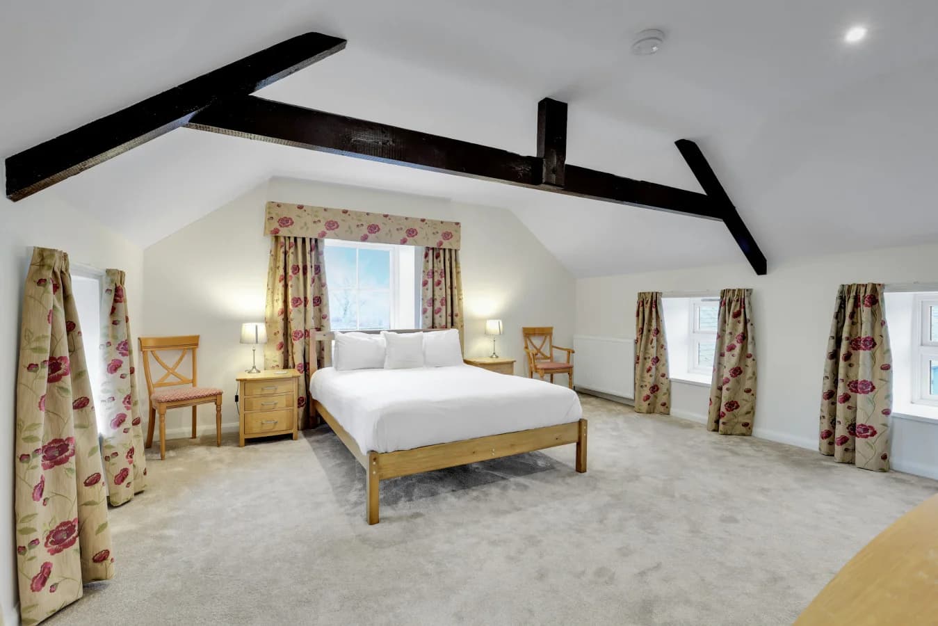 Bright king bedroom combining farmhouse charm and modern comfort