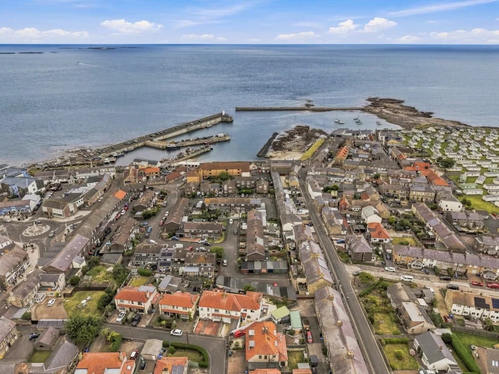 Aerial view of Seahouses harbour, marina and Northumberland coastline.