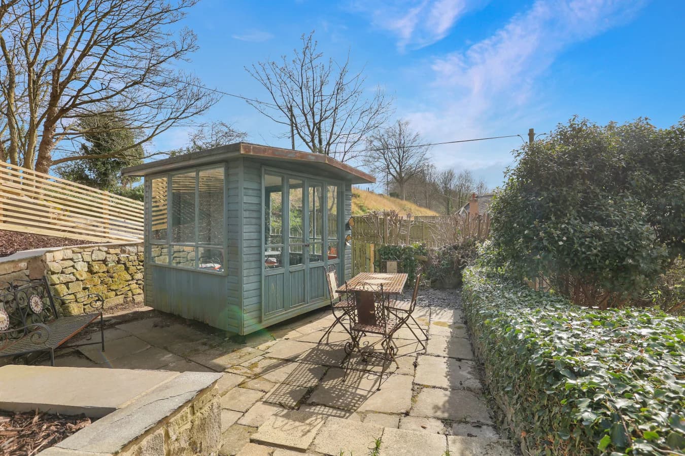 Garden summer house with paved terrace and outdoor seating area
