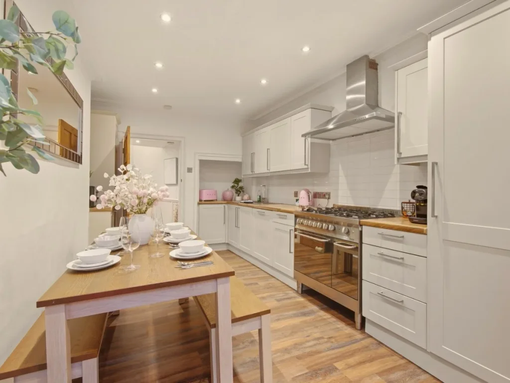 Spacious kitchen and dining area with range cooker and wooden bench seating.