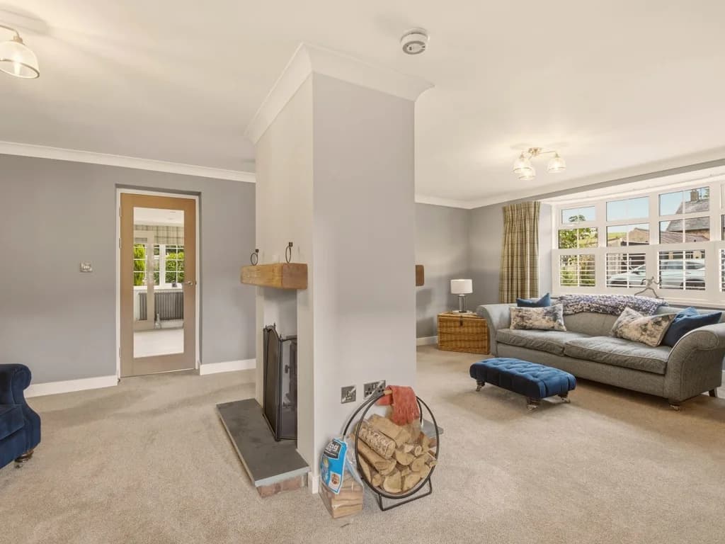 Spacious lounge with central fireplace creating a warm and welcoming focal point