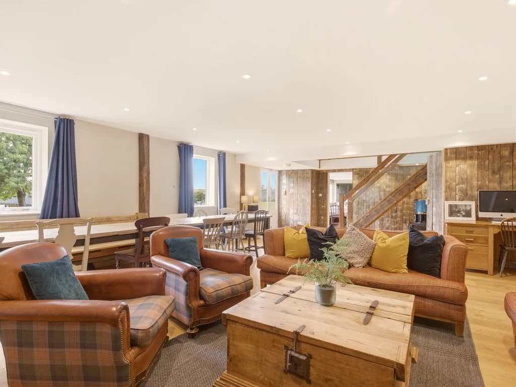 Open-plan ground floor with dining space and exposed timber features
