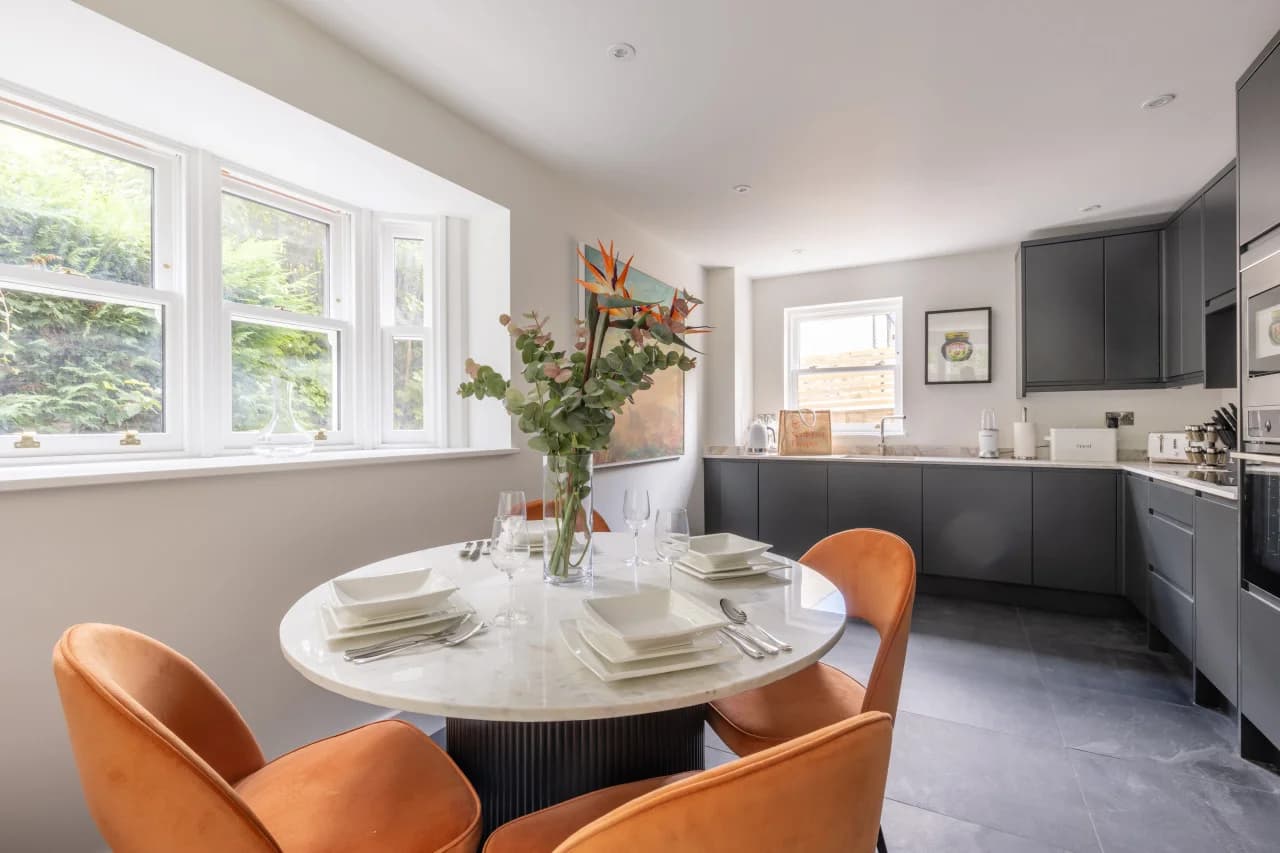 Quartz dining table beside the contemporary kitchen