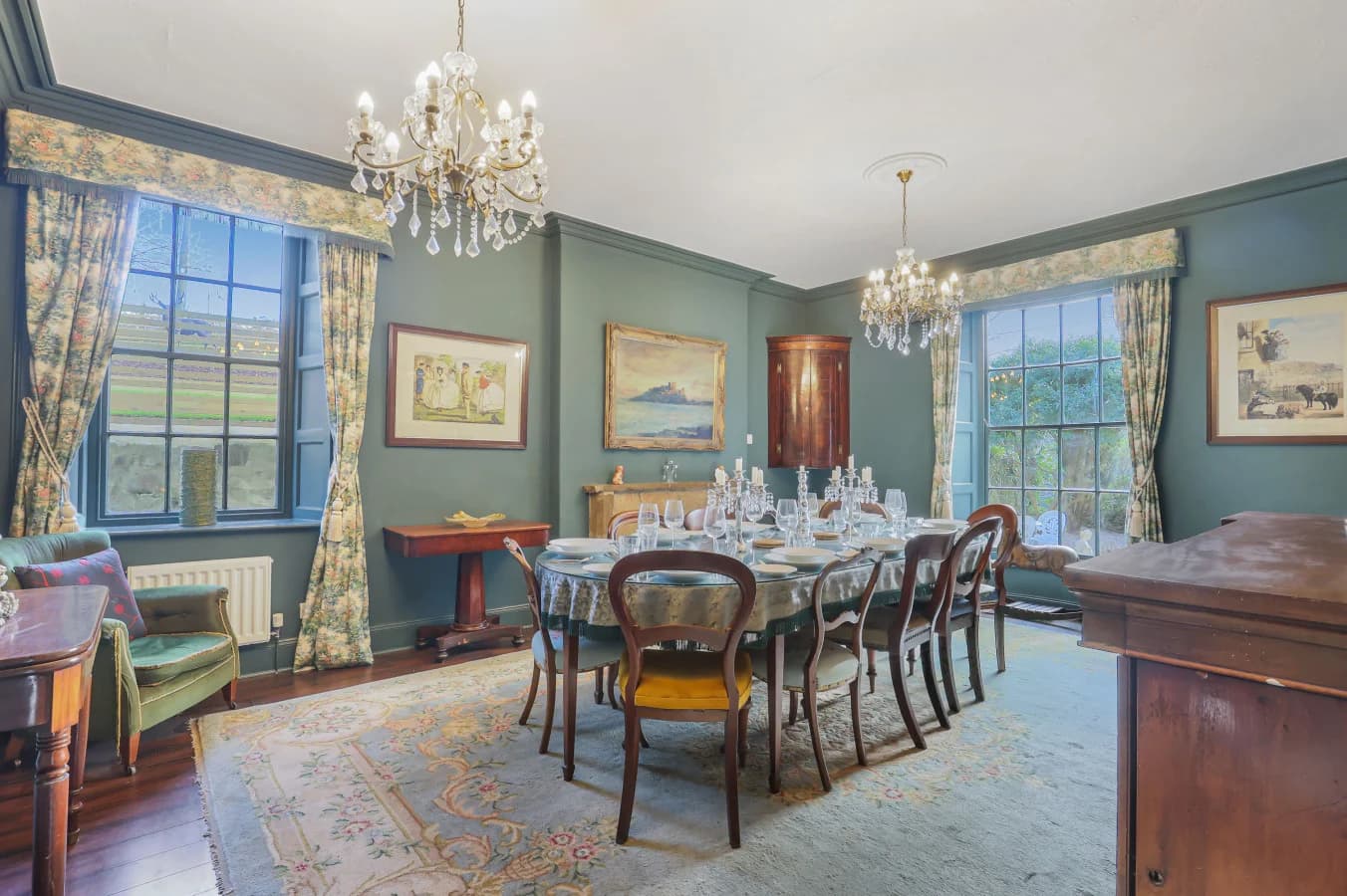Spacious dining room with antique furnishings and large sash windows