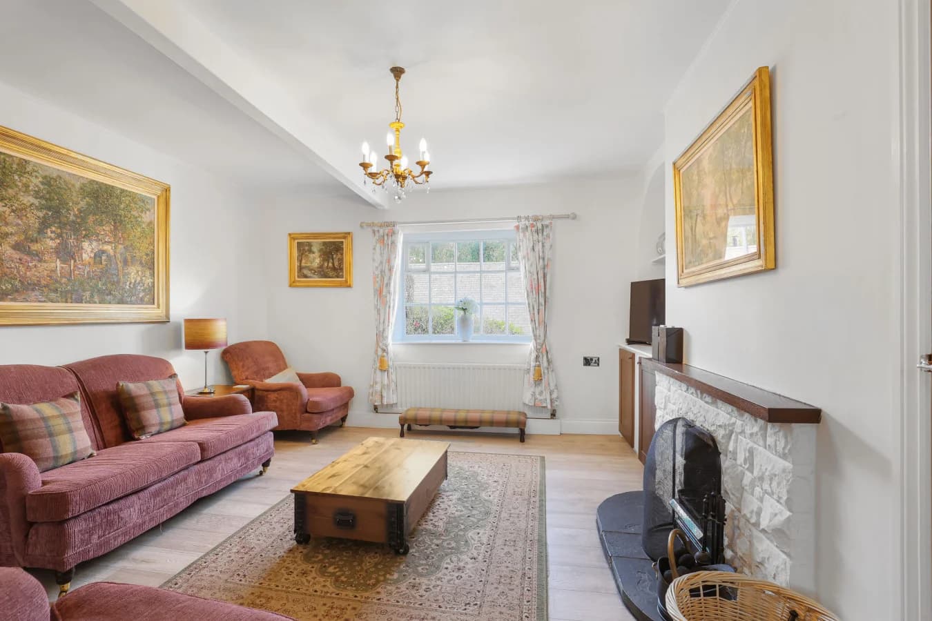 Lounge with open fire, patterned rug and timber coffee table