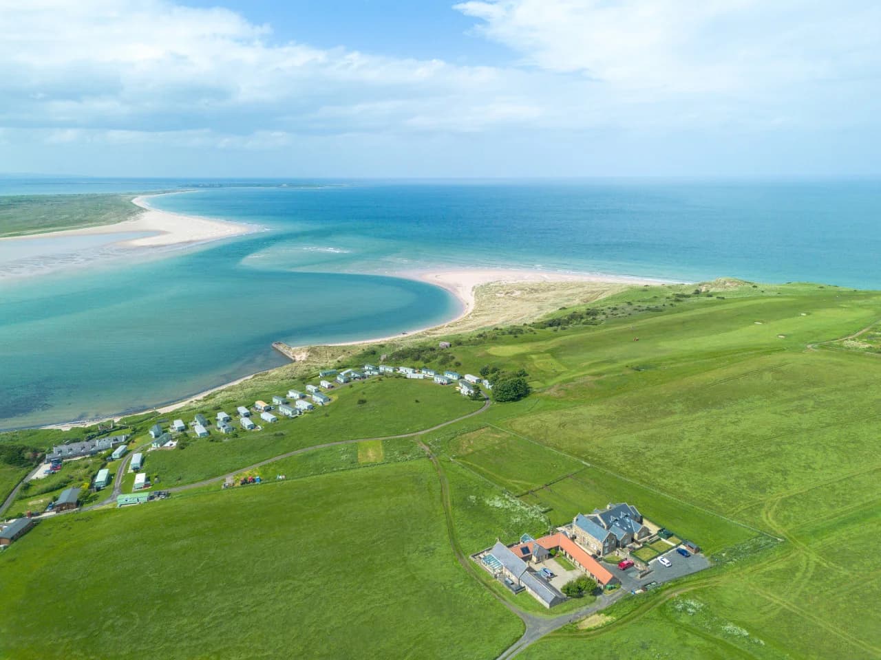 Aerial view of Budle Bay and the cottage setting