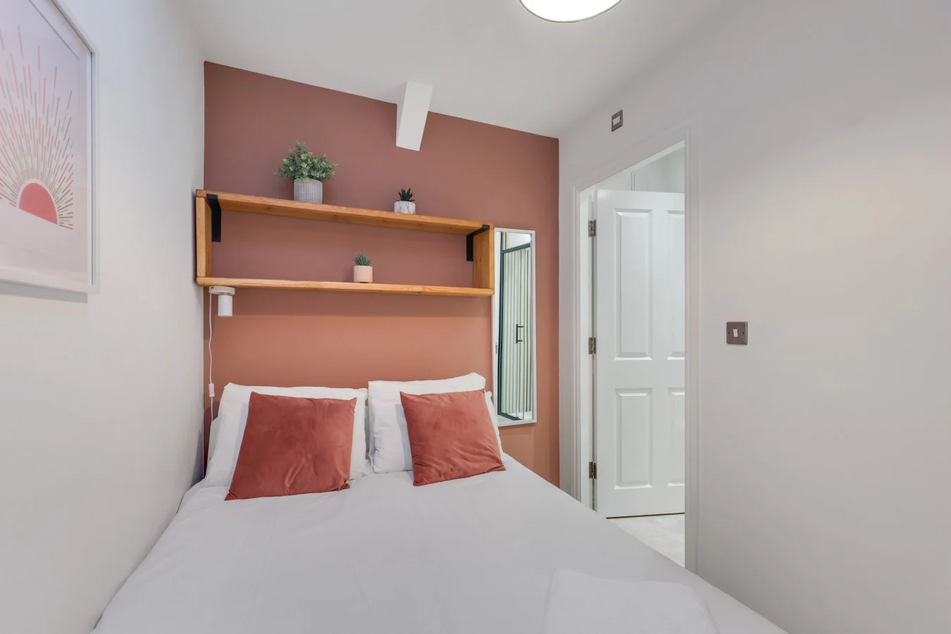 Double bedroom with open shelving, soft tones and natural light