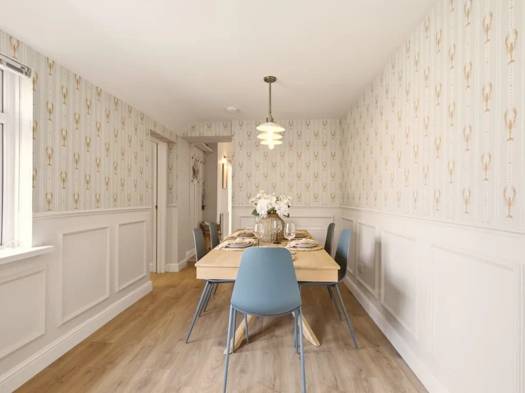 Spacious dining room with wood flooring and six-seat dining table