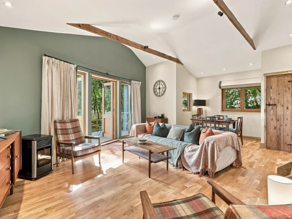 Bright living area with exposed beams and comfortable seating